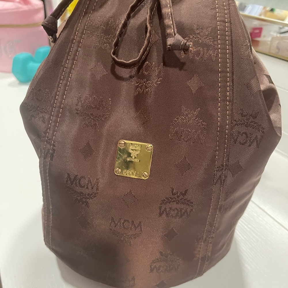 Vintage. MCM Brown Logo NylonDrawstring Monogram Sling Backpack with Gold Plaque
